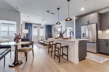 Wood-style flooring in living, dining, and bath areas